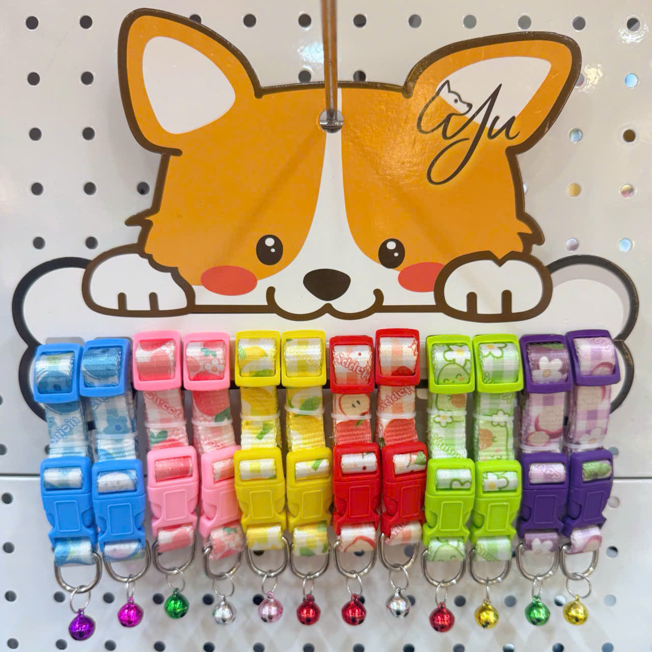 Rack of colorful cat collars with bells